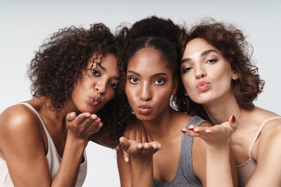 Group of ladies posing with kissing posture | Glow Beauty Bar in Smyrna, GA