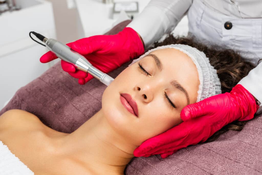 A Lady taking microneedling by cosmetologist | Glow Beauty Bar in Smyrna, GA